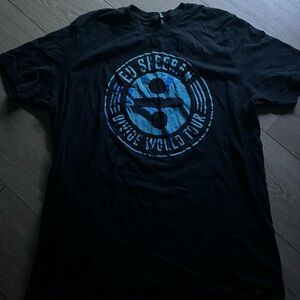 Black Short‑Sleeve Graphic T‑Shirt with Blue Tour Emblem